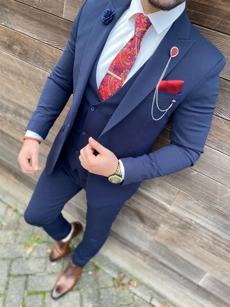 Homme en costume bleu marine avec cravate rouge à motifs