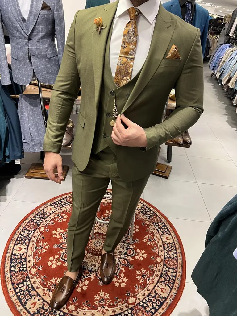 Homme portant un costume vert avec cravate à motifs
